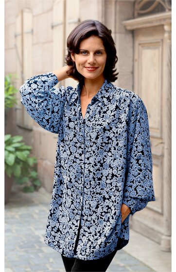 Weite Bluse in Dunkelblau mit weißem Blumenmuster, lange Ärmel mit Gummizug, u-förmiger Halsausschnitt, durchgehend geknöpft, getragen von lächelnder Frau, locker sitzend