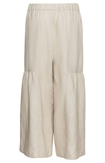 Weite Culotte-Hose in hellbeige, hoher elastischer Bund, gerader Schnitt mit angedeuteten Nähten unterhalb der Knie, knöchellang, ohne Muster oder weitere Details