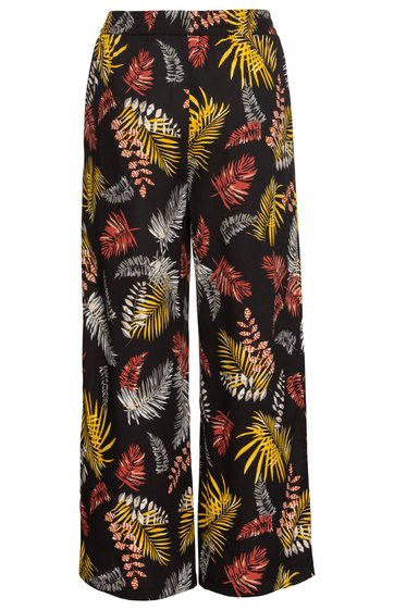 Schwarze lange Hose mit weitem Bein, gemustert mit großen Blättern in Gelb, Rot, Weiß und Braun, elastischer Bund, gerade geschnitten