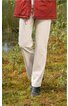 Beige lange Hose ohne Muster, gerade geschnitten, getragen von Person im Stehen, kombiniert mit schwarzen Schuhen und rotem Mantel