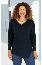 Schwarzer Pullover mit asymmetrischem Saum, V-Ausschnitt mit drei goldfarbenen Knöpfen an der linken Schulter, lange Ärmel, getragen von stehender Frau mit lockigem Haar