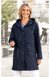 Damenparka in dunkelblau, schlichtes Design, Kapuze mit Tunnelzug, vorn Knopfleiste, zwei aufgesetzte Taschen mit Klappen, Taillenzug, langärmlig, getragen von lächelnder Frau in stehender Pose