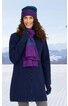 Marineblauer Mantel, langer Schnitt, durchgehender Reißverschluss, getragen von stehender Frau, dazu violett-blauer Schal, violette Mütze, marineblaue Handschuhe, winterliche Schneelandschaft im Hintergrund