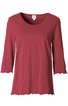 Rotes Langarmshirt mit Rundhalsausschnitt, leicht ausgestelltem Schnitt, gewelltem Saum an Ärmeln und unterem Saum
