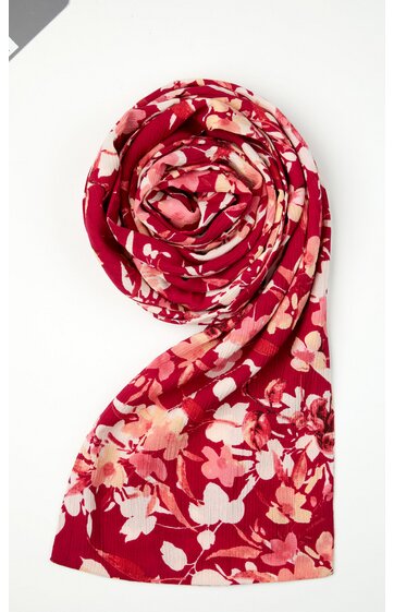 Schal in kräftigem Rot mit floralem Muster in Rosa und Hellbeige, länglich, leicht gewellt, ohne sichtbare Verschlüsse oder Fransen