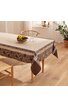 Rechteckige Tischdecke in beige und braun mit floralem Muster, breite gemusterte Bordüre, auf Esstisch mit Holzbeinen, einzelne Glasgläser und Schale mit Obst darauf, helle, minimalistisch eingerichtete Küche
