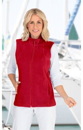 Rote ärmellose Stehkragenweste mit Reißverschluss und Seitentaschen, getragen von stehender Frau mit weißem Langarmshirt, sportlicher Look