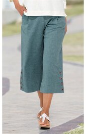 Damenhose, türkisgrün, knielang, weites Bein, seitliche Eingrifftaschen, Knopfdetails am Saum, getragen von Person im Stehen