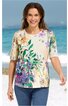 Kurzärmeliges Shirt in Creme mit buntem Blumenmuster in Grün, Lila, Orange und Gelb, Rundhalsausschnitt, gerade geschnitten, getragen von lachender stehender Frau am Strand