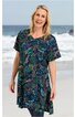 Tunika in Dunkelblau mit buntem Paisley-Muster, V-Ausschnitt, kurze Ärmel, locker sitzend, getragen von lächelnder stehender Frau vor Strandkulisse
