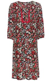 Knielanges Kleid mit floralem Muster in Rot, Weiß und Grün auf schwarzem Grund, rundem Ausschnitt mit rotem Einsatz und Bändern, lange lockere Ärmel, locker geschnitten