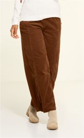 braune weite Baumwoll-Hose mit feinem Cord-Struktur, getragen von Person mit weißem Pullover und hellbeigen Stiefeletten, helle neutrale Hintergrundfarbe