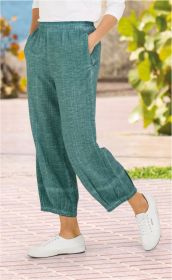 Baumwoll-Hose in Türkis mit elastischem Bund, bequemer weiter Schnitt, seitliche Eingrifftaschen, getragen mit weißen Sneakern auf gepflastertem Weg vor sommerlicher Außenkulisse mit grünen Pflanzen.