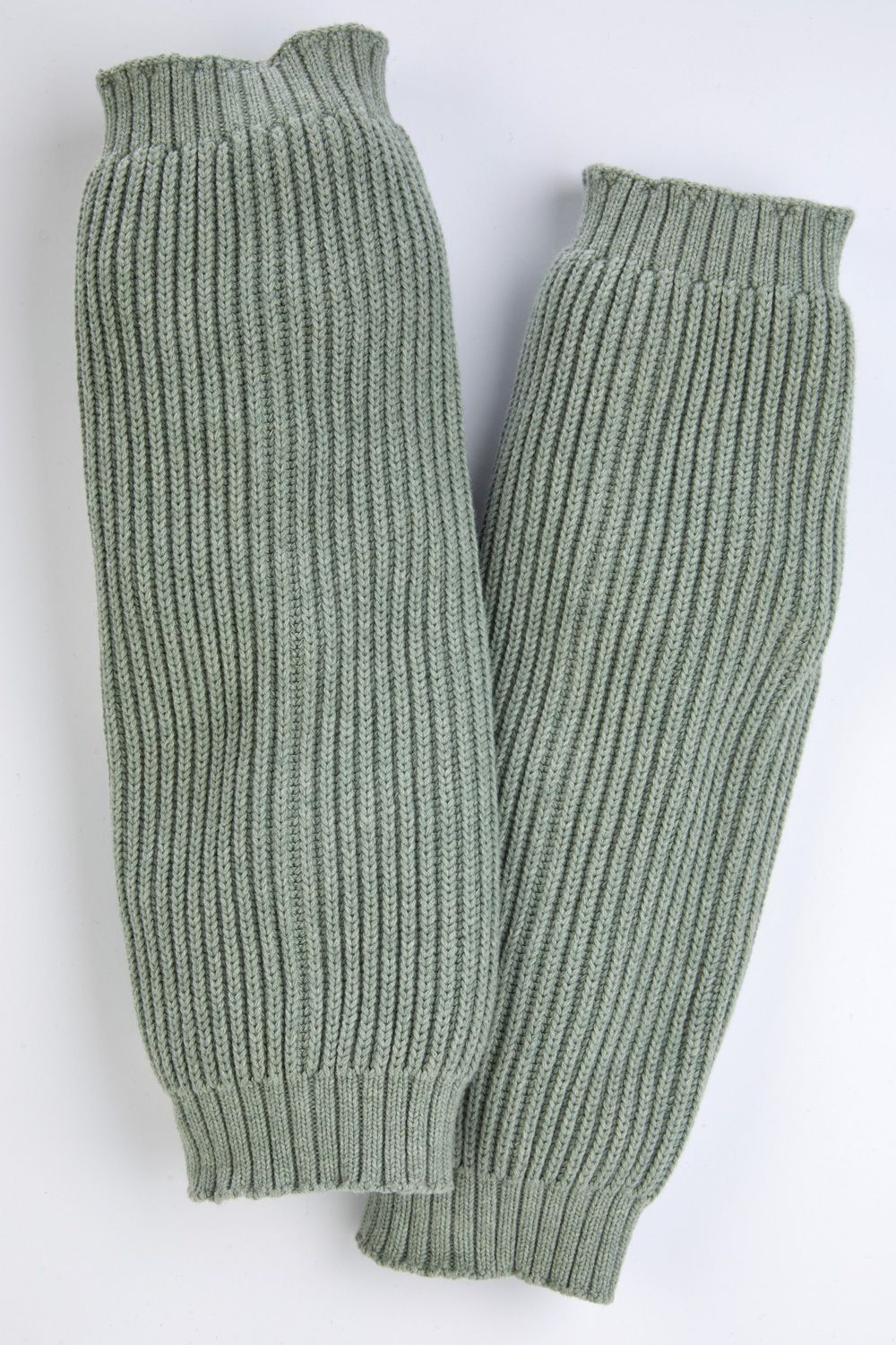 Zwei flachliegende, hellgrüne Baumwoll-Mix-Stulpen mit geripptem Strickmuster, elastischen Bündchen oben und unten, auf weißem Hintergrund